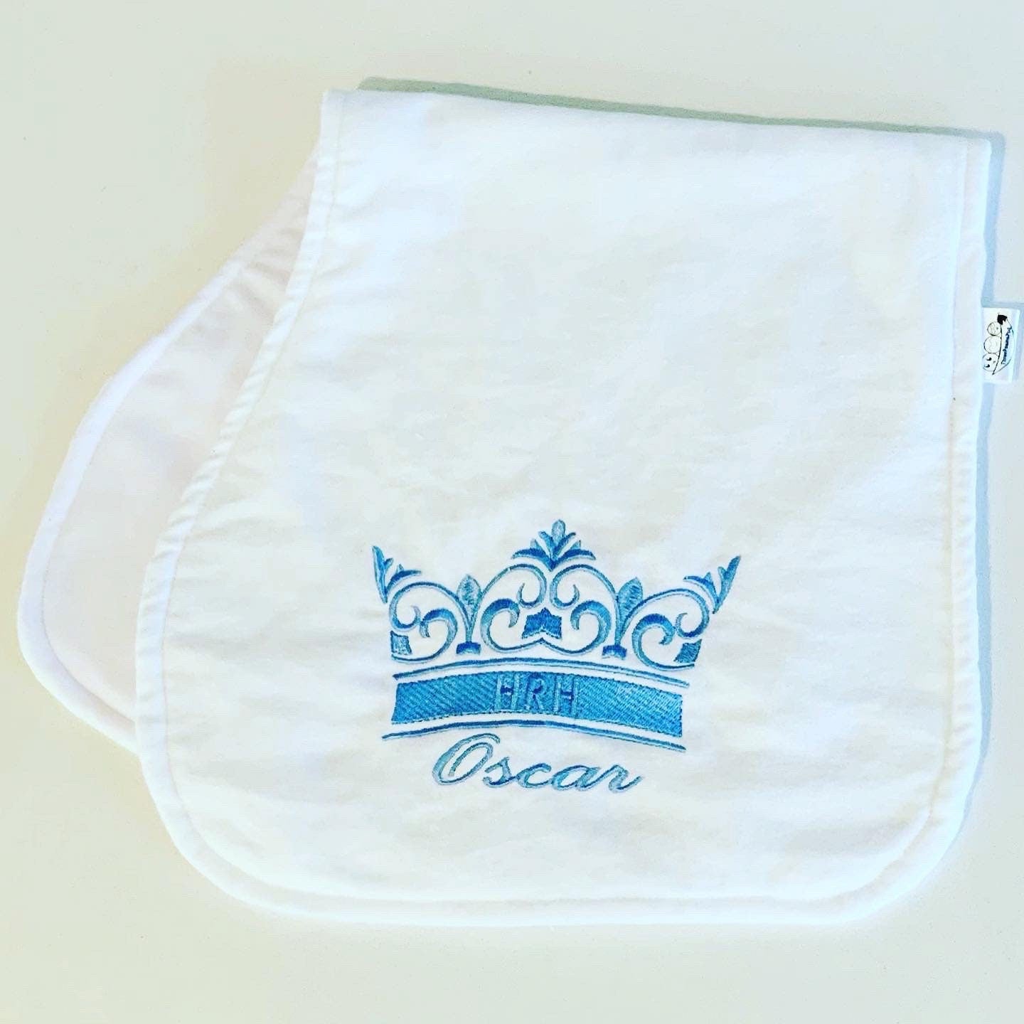 Personalised burp cloth with an embroidered crown and baby's name in Blue Thread Colour. 