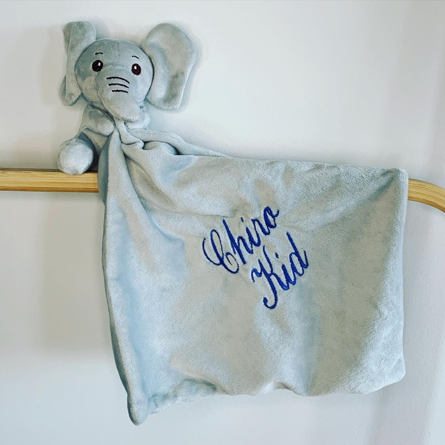 Personalised Elephant baby comforter embroidered with baby's name in blue thread. Baby comforter is a plush elephant attached with a mini baby blanket. 