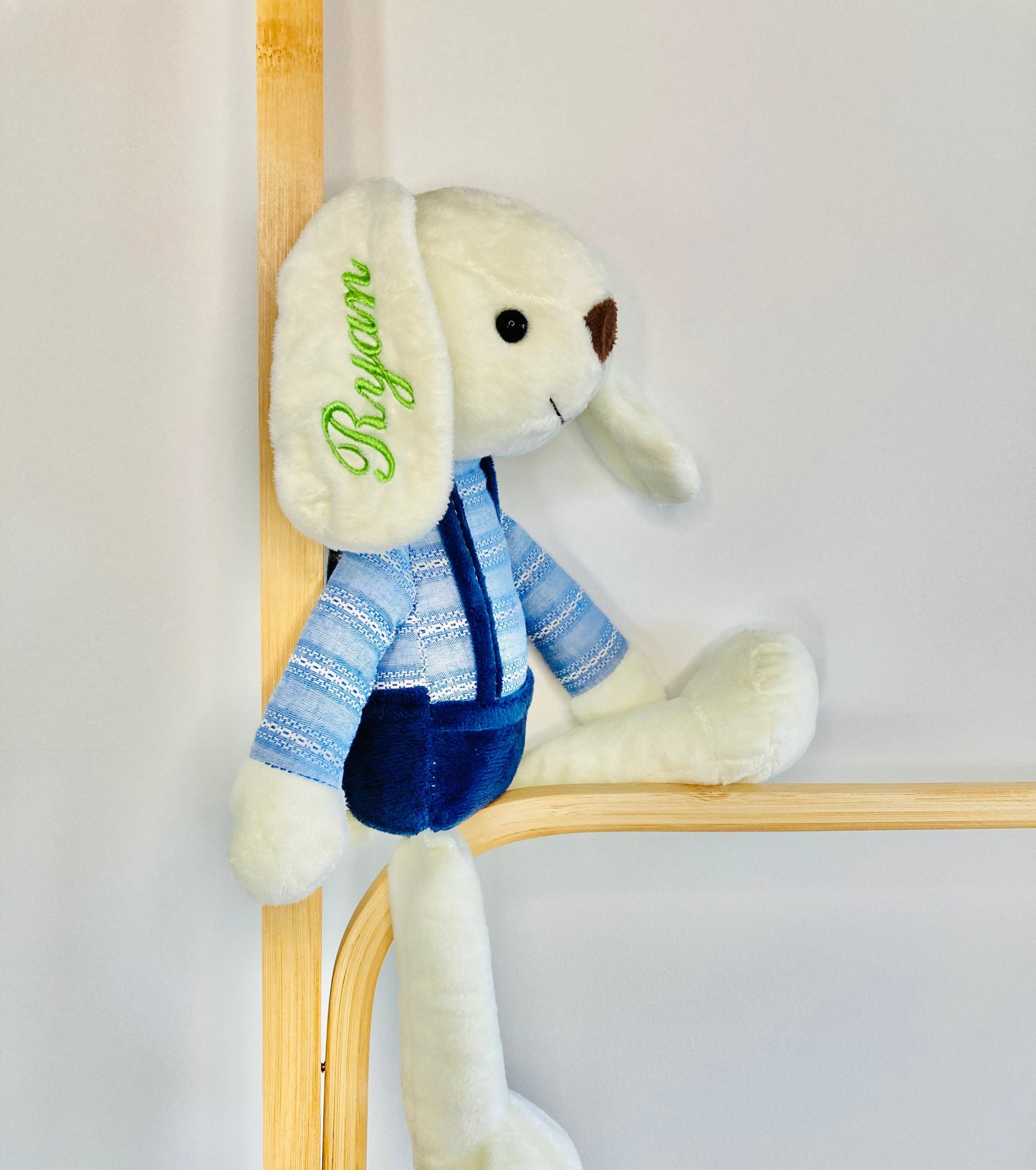 Plush bunny in blue overalls, personalised with baby's name on the bunny ear.